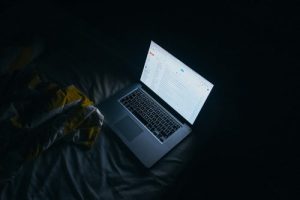 Girl in front of laptop trying to find reliable movers.