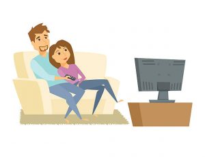 A couple watching a TV show on the couch, preparing for moving from Canada to Brazil