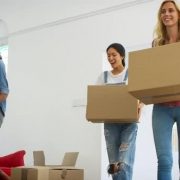 Friends moving boxes, packing for international relocation