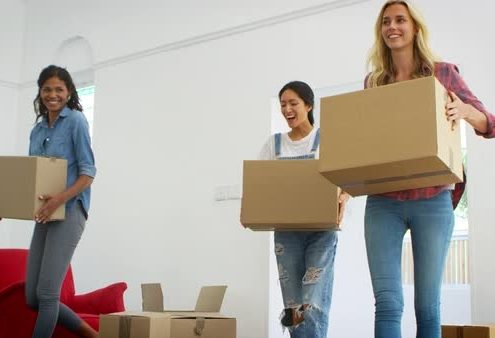 Friends moving boxes, packing for international relocation