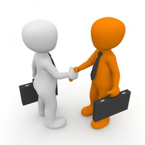 Two people shaking hands - the start of a long-term partnership with One MOving & Logistics.