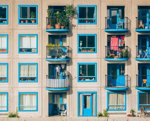 Apartment building with blue windows and small balconies