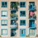 Apartment building with blue windows and small balconies