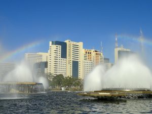 Buildings and fountains in Brasilia; clear sky with a rainbow